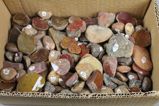 A box containing a collection of various Victorian polished pebbles