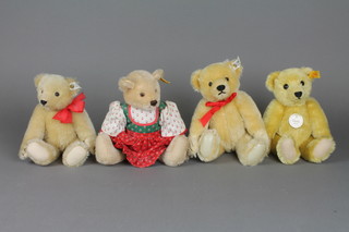 A Steiff reproduction 1909 yellow bear 9", 2 Steiff yellow bears with articulated limbs 9 1/2" and 9" and  a girl teddybear wearing a dress 10"