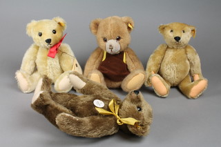 A yellow Steiff teddybear with articulated body 11", ditto with growler 13", a brown Steiff bear wearing an apron 12" and a 1909 reproduction Classic Steiff teddybear 11"