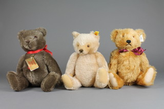 A yellow Steiff teddy bear with articulated limbs 12", a light yellow ditto 11" and a brown Hermann bear 12" 