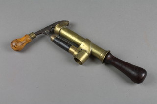 A brass and wooden shotgun cartridge primer 8" 