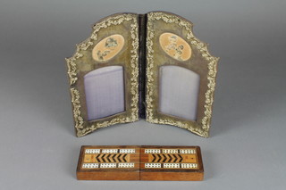 An inlaid mahogany cribbage board in the form of a box with hinged lid 2" x 5" extending to 10" together with a folding repousse photo frame