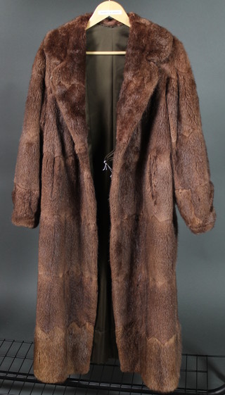 A lady's brown full length fur coat