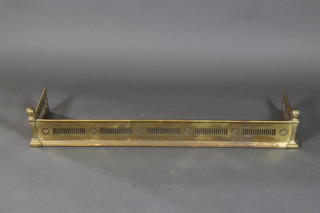A pierced brass fender 7 1/2"h x 48"w x 12 1/2"d