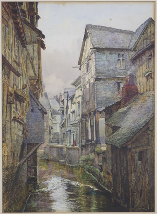 L. Sandys Stanyon, watercolour, a townscape view of Caudebec with figures beside a stream running through the town, signed 15" x 11" 