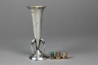An Edwardian hammer pattern tapered silver spill vase on splayed foot, London 1904, maker David Aitken, approx. 5 ozs 7" and 3 silver thimbles