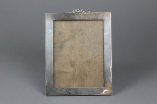 A rectangular silver photograph frame with ribbon crest, 9.75" x 7.75", Birmingham 1923