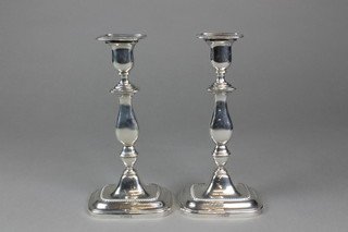 A pair of Georgian design silver baluster candlesticks with gadrooned rims and weighted bases, Sheffield 1915, 9.5"