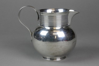 An Edwardian silver baluster water jug with ribbed decoration and S scroll handle, Chester 1904, approx. 20 ozs 