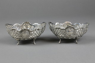 A pair of 19th Century Continental pierced bon bon dishes with vacant cartouches on scroll feet, approx 8 ozs 
