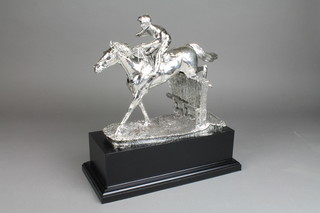 A filled silver horse racing trophy in the form of a jockey up, on an ebonised socle, 16"