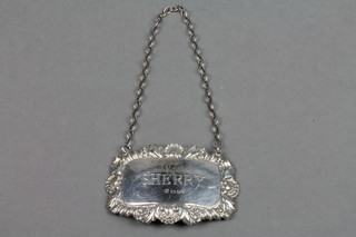 A repousse silver sherry label