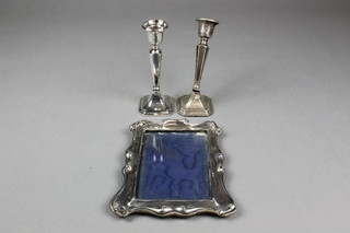 A pair of dwarf silver tapered candlesticks, Chester 1919, 7" (1f), a ditto silver scroll photo frame 7" x 4" (f)