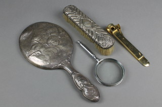 A Victorian repousse silver hand mirror with Reynolds Angels decoration, a silver backed brush and 2 other items