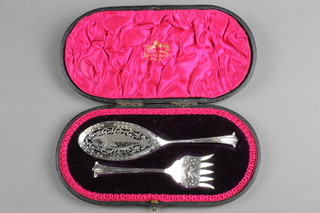 A pair of cased Victorian silver fish servers with chased and pierced decoration, Sheffield 1899