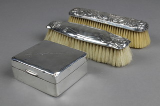 A silver cigarette box 3" and 2 silver backed clothes brushes