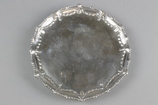 A George III silver card tray, the fancy rim with swags and flowers on claw and ball feet, London 1771, 7.5" 
