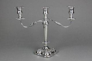 A silver 3 light candelabrum with repousse scroll and floral decoration and tapered stem on stepped base by Viners, Sheffield 1955 14"
