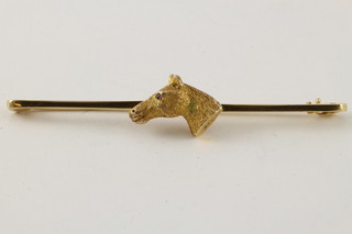 A 9ct gold horse head bar brooch with gem set eye