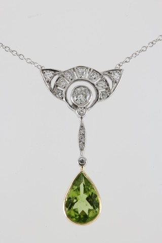 A white gold Edwardian style diamond and peridot drop pendant on an 18ct white gold chain
