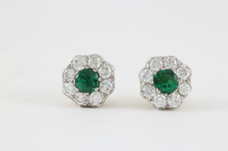 A pair of 18ct yellow gold emerald and diamond cluster ear studs, the centre stone approx. .25ct surrounded by 8 brilliant cut diamonds 