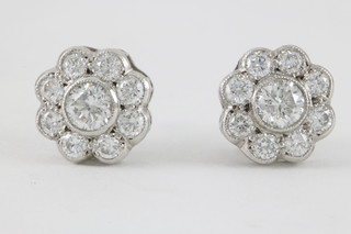 A pair of 18ct white gold diamond cluster ear studs set with 9 brilliant cut stones, approx 0.9ct 