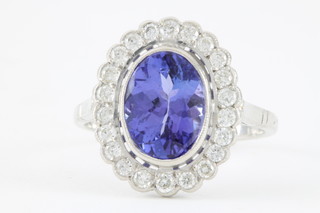 An 18ct white gold tanzanite and diamond cluster ring, the centre stone approx 3.15ct, surrounded by 22 brilliant cut diamonds, approx 0.5ct