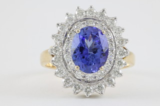 An 18ct yellow gold oval tanzanite and diamond cluster ring, the centre stone approx. 1.5ct surrounded by 34 brilliant cut diamonds approx. 1 ct