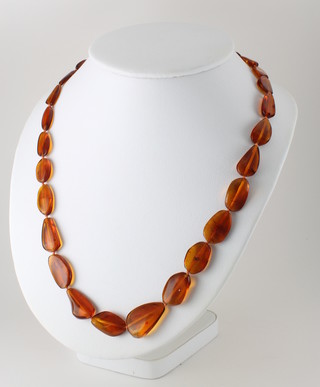 A string of flattened amber beads 23"