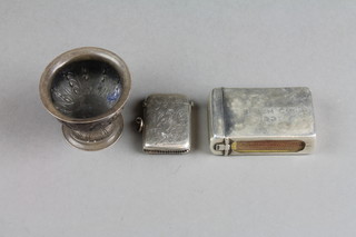 A silver match sleeve, Birmingham 1926, a scroll decorated silver vesta and a Continental repousse silver salt