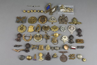 A quantity of WWII and other brass and cloth badges