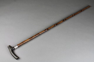 A silver mounted horn handled faux bamboo walking cane