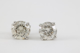 A pair of 18ct white gold single stone diamond ear studs, approx 1ct and 1.04ct