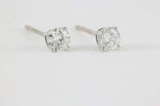 A pair of white gold single stone diamond ear studs