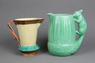 A Sylvac water jug in the form of a giant acorn with squirrel handle 1959, 9" and an Art Deco Dunedin jug 8" 