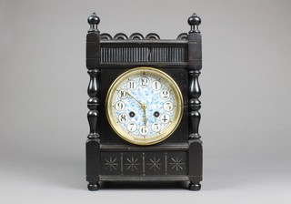 A Victorian 8 day striking aesthetic movement mantel clock with floral porcelain dial and Arabic numerals contained in ebonised case 