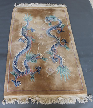 A yellow ground Chinese rug decorated 2 dragons 86" x 48 1/2"