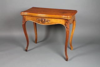 A Victorian carved walnut fold over serpentine card table, on carved cabriole legs 29"h x 32"w x 64"d 