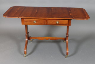 A Georgian style yew sofa table fitted 2 long drawers, raised on standard end supports with H framed stretcher and brass caps and casters 29 1/2"h x 33"w x 54"w when opened by 23 1/2"d
