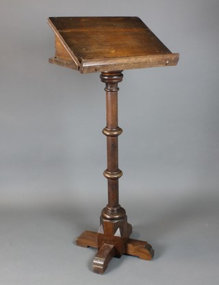 A Victorian carved oak lectern raised on a turned column with X framed base 54"h x 22"w x 14 1/2"d