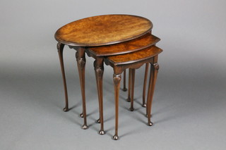 A nest of 3 Queen Anne style oval figured walnut interfitting coffee tables on cabriole legs 20"h x 23"w x 16"d