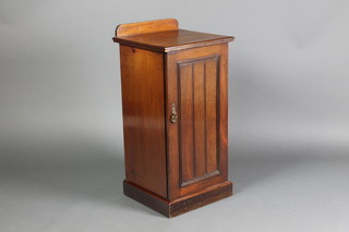A Victorian walnut pot cupboard with raised back enclosed by a panelled door raised on a platform base 32 1/2"h x 15" 1/2"w x 15 1/2"d