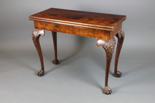 A Georgian rectangular mahogany flip over top card table, the playing surface fitted 4 counter wells, raised on cabriole ball and claw supports 28 1/2"h x 36"w x 16 1/2"d