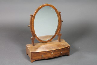 A Georgian oval plate toilet mirror, raised on a mahogany stand, the bow front base fitted 1 long drawer with ivory escutcheon and satinwood crossbandings 18 1/2"h x 15"w x 7" 1/2d 