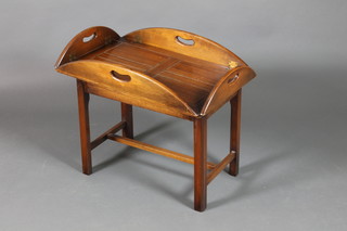A Georgian style oval mahogany drop flap butler's tray, raised on a stand 19"h x 34"w x 25"d
