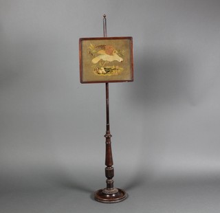 A Victorian rosewood pole screen with banner decorated a bird 