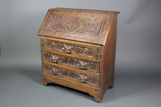 A Victorian carved oak bureau, the fall front revealing a fitted interior with 3 drawers and 8 pigeon holes above 3 long drawers with carved lion handles, raised on bracket feet 38 1/2"h x 35"w x 15"d