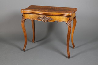 A mid Victorian walnut serpentine card table with carved scrolled mouldings on scroll knees and serpentine legs 29"h x 33"w x 34"