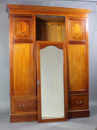 An Edwardian inlaid mahogany wardrobe with moulded cornice enclosed by a panelled door and flanked by a pair of inlaid panels, the base fitted 2 drawers and raised on a platform base 82"h x 64"w 