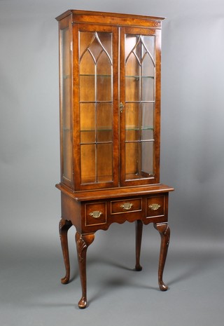 A Queen Anne style walnut display cabinet on stand, the upper section with moulded cornice fitted adjustable shelves enclosed by astragal glazed doors, the base fitted 1 long and 2 short drawers, raised on cabriole supports 72"h x 27"w x 17 1/2"d 
